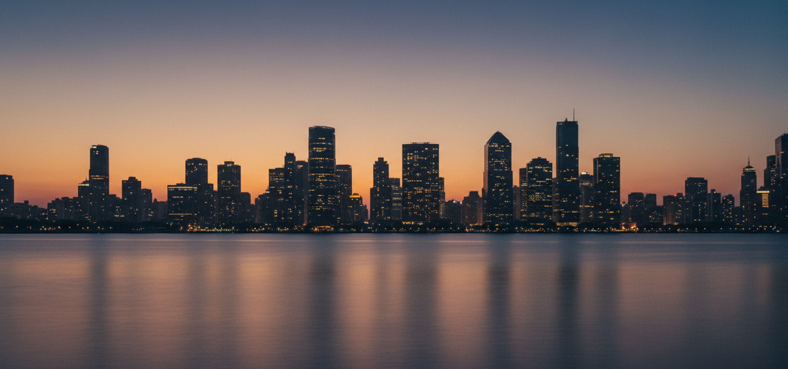 Dusk skyline of a South Asian financial district seen across open water