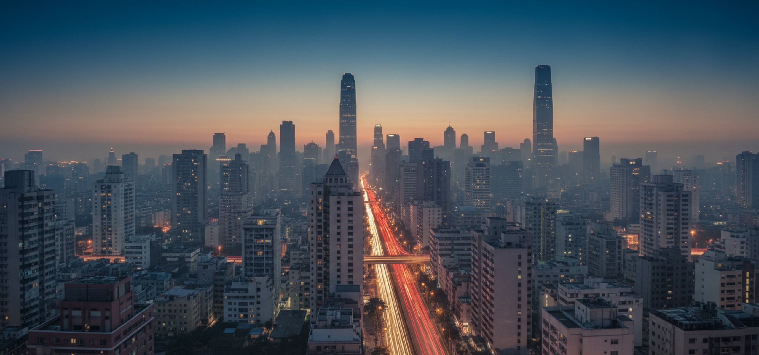 Elevated view of a dense city intersection with light trails at dusk